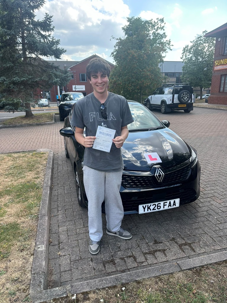 Student with pass certificate and L-plate car